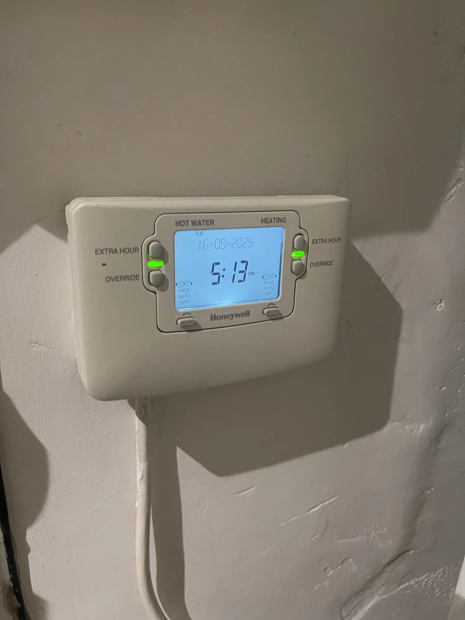 Honeywell heating and hot water programmer fitted to a wall